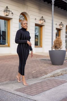 Step out in style with this sleek black turtleneck midi dress, designed for the woman who loves a chic, understated look with a hint of edge. Featuring shimmering rhinestone pinstripes that elongate the figure, this dress offers a sophisticated silhouette that hugs your curves in all the right places. The turtleneck design adds a polished touch, while the fitted long sleeves keep the look elegant and versatile. Perfect for both formal and semi-casual occasions, this dress is easy to style with h Chic Turtleneck Midi Dress For Party, Elegant Spring Turtleneck Midi Dress, Spring Evening Turtleneck Midi Dress, Winter High Neck Midi Dress For Date Night, Black Fitted Turtleneck Midi Dress, Black Turtleneck Midi Dress, Fitted, Chic Turtleneck Midi Dress For Night Out, Elegant Turtleneck Midi Dress For Work, Sleek Midi Dress For Winter Night Out