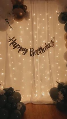 a birthday backdrop with balloons and lights