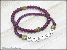 ** Fits up to size 6 3/4 inch wrist.  (M). **  This stretch bracelet set is made with 4mm and 6mm purple faceted glass beads, 6mm acrylic letter beads, and antiqued gold spacer beads. This set features the word MYSTERY.   Stackable Inspirational Word Bracelet, Purple Mystery Beaded Bracelets, Word Jewelry, Affirmation Mantra Bracelets, Gift Set Affordable Purple Stretch Bracelet With Letter Beads, Adjustable Purple Beaded Bracelets With Letter Beads, Everyday Purple Jewelry With Letter Beads, Purple Stretch Bracelet With Letter Beads For Birthday, Purple Stretch Bracelet With Letter Beads, Mantra Bracelet, Acrylic Letters, Word Bracelet, Jewelry Words