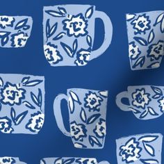 a blue and white pattern with coffee mugs on the left side, and flowers on the right side