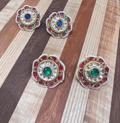 Navaratan Studs in four different patterns Multicolor Fusion Style Jewelry With Motifs, Fusion Style Multicolor Motif Jewelry, Multicolor Round Temple Jewelry Earrings, Multicolor Motif Earrings For Wedding, Multicolor Motifs Earrings For Wedding, Multicolor Intricate Earrings For Diwali, Multicolor Intricate Design Earrings For Diwali, Traditional White Plug Earrings As Gift, Multicolor Diwali Earrings With Intricate Design