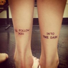 two people with tattoos on their legs that say i'll follow you into the dark