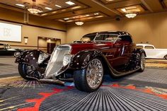 an antique car is on display in the lobby