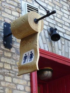 a toilet paper dispenser hanging from the side of a brick building