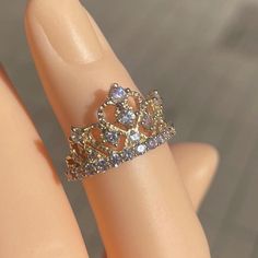 a close up of a person's hand with a ring on top of it