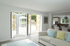 a living room filled with furniture and sliding glass doors leading to an outdoor dining area