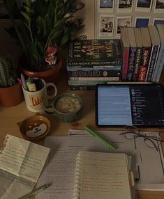 an open book sitting on top of a wooden desk next to a cup of coffee