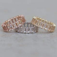 "This Emerald Cut Morganite Eternity Band features several genuine, emerald cut, AAA peachy pink morganites. They are hand-set in the solid metal of your choice! Curves of metal encircle each like the leaves of a Lily Flower. The morganites are of the highest quality, averaging 5x3mm and 0.31 carats each. Choose from the following sizes: Sizes 3 - 5.5: 18 morganites, 5.58 ctw Sizes 5.75 - 8: 20 morganites, 6.2 ctw Sizes 8.25 - 10: 23 morganites, 7.13 ctw All shapes and sizes and gemstones availa Morganite Wedding Band, Diamond Stacking Rings, Pink Morganite, Stacked Jewelry, Eternity Wedding Band, Put A Ring On It, Silver Accessories, Womens Wedding Bands, Gold Accessories