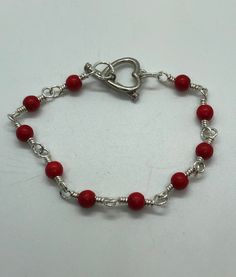 Silver and red bead wire wrapped bracelet. (Tarnish resistant silver colored wire) see photo with ruler for sizing.. Nickel-free Red Sterling Silver Bracelet, Red Metal Beaded Bracelet With Round Beads, Red Adjustable Wire Wrapped Bracelets, Adjustable Red Wire Wrapped Bracelets, Adjustable Red Wire Wrapped Bracelet, Red Bracelets With Silver Beads For Jewelry Making, Red Adjustable Sterling Silver Beaded Bracelets, Adjustable Red Sterling Silver Beaded Bracelets, Handmade Red Metal Bracelets