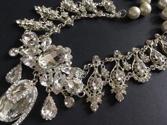 "Perfect for all bridal or party to wear!! Victorian shaped necklace featuring sparkle pendant set in center and linked to pearls chain on both sides. Color: clear rhinestone crystals, glass stones and pearls Size: necklace measures around 19.25\" long x center sparkle 4\" x 3\" Item ship out with tracking number to you (around 10 to 14 business days for delivery). We also provide fast shipping service, around 3-4 business days delivery but need to add extra charge. Please convo us if need." Exquisite Bridal Necklace With Sparkling Stones For Party, Glamorous Cubic Zirconia Jeweled Bridal Necklace, Glamorous Bridal Necklace With Jewels In Cubic Zirconia, Glamorous Cubic Zirconia Bridal Necklace With Jewels, Exquisite Crystal Wedding Necklaces, Exquisite Crystal Necklaces For Weddings, Exquisite Crystal Wedding Necklace, Exquisite Crystal Bridal Necklace For Party, Exquisite Crystal Jewelry Sets For Parties