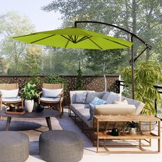 an outdoor living area with couches, tables and umbrellas