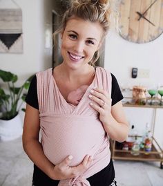 a woman holding a baby in her arms