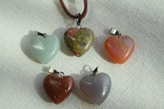 "These are multi-colored gemstone heart shaped healing chakra crystal quartz stone pendants. The pendants are 15 - 16 mm in size with 18\" leather cord necklaces with silver medal clasps. Each necklace has a two inch extension chain to allow you some flexibility in fit. You pick the color of your necklace!! These would make a beautiful present for Valentines Day or any time of the year. If you would like a chain necklace rather than a leather cord necklace just send me a message. I have a variet Heart-shaped Crystal Necklace With Natural Stones For Healing, Heart-shaped Natural Stone Crystal Necklace For Healing, Healing Heart-shaped Crystal Gemstone Necklace, Handmade Heart Crystal Necklaces For Healing, Handmade Heart-shaped Crystal Necklaces For Healing, Handmade Heart-shaped Crystal Necklace For Healing, Heart Stone Necklace, Cord Necklaces, Leather Corded Necklace