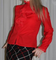 Find vintage heaven with this all-frills blouse by RIO. It's pure 60s Go-Go style in shocking red...you will not be missed! Pair with some authentic Bell-Bottoms or an A-line mini maybe.  This blouse is smallish. I would say a modern UK size 8 (34 inch bust), this is my size and it fits me well even though I have broad shoulders and an athletic build. This blouse is super-cute with its little mandarin collar and front frills. The sleeves are delicately puffed and gathered at the wrist. Also the Frills Blouse, Frill Blouse, Athletic Build, Broad Shoulders, Checked Jacket, Vintage Blouse, Drip Dry, Blouse Vintage, Mandarin Collar