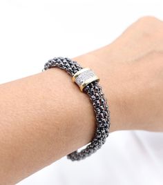 Crafted with a sleek black metallic mesh, this single station bracelet is a must-have accessory for any outfit. The lightweight and versatile design offers both style and comfort, making it perfect for everyday wear. Elevate your look with this modern and trendy bracelet. Size: 6 1/4 inches - Inner Diameter Closure: Magnetic Clasp Material: Brass with 18K Gold Plating with Rhodium Coating Lead Free and Hypoallergenic Elegant Black Braided Bracelet For Formal Occasions, Elegant Adjustable Magnetic Beaded Bracelets, Elegant Black Beaded Bracelets With Magnetic Clasp, Elegant Black Magnetic Beaded Bracelets, Elegant Black Magnetic Bracelets, Elegant Black Metal Braided Bracelets, Silver Magnetic Bracelets, Trendy Bracelet, Metallic Mesh