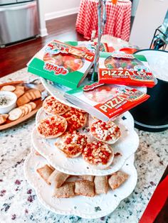 pizza and crackers are stacked on top of each other in front of the stove