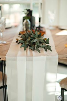 a wooden table topped with a vase filled with flowers