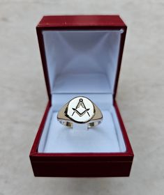 Square and Compass Masonic Ring, made out of 9K Gold, classic chevalier design that bares the motife of the Order. Due to its simplicity, it's ideal for the small finger. Available in large quantities other metals and other stones upon request.  Box dimensions of 45 Χ 50 Χ 40 mm having a total weight of 45 grams.  The price DHL shipping with tracking number. Classic Yellow Gold Signet Ring With Maker's Mark, Classic Yellow Gold Engraved Ring With Maker's Mark, Classic Engraved Yellow Gold Ring With Maker's Mark, Classic 14k Gold Adjustable Engraved Ring, Adjustable Classic 14k Gold Engraved Ring, Adjustable 14k Gold Classic Signet Ring, Symbolic Silver-colored 14k Gold Signet Ring, Symbolic Silver Signet Ring In 14k Gold, 14k Gold Signet Ring With Maker's Mark As Gift