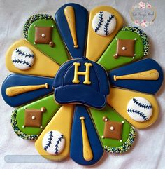 a decorated cookie with baseballs, mitts and hats on it's side