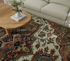 a living room with a couch, coffee table and rug