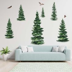 a living room with three green trees on the wall and two birds flying in the air