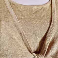 "This elegant metallic gold blouse with scoop neckline and long sleeves is vintage item from 1990s. This simple yet classic top is the perfect completion to a 1990s look, wedding, or Christmas party outfit. Made of stretchy material, knitted with shimmery gold lurex, this fabric will give you a comfort and beautiful look. The top is layered with attached short jacket, that ties on the center. - Scoop neck - Long sleeves - Front layered top attached on the sides, ties in the center - Feminine fit Gold Festive Blouse For Fall, Festive Gold Blouse For Fall, Gold Long Sleeve Top For Evening, Gold Long Sleeve Top For Party, Fitted Gold Top For Holidays, Elegant Gold Tops For Holiday, Elegant Gold Tops For Holidays, Elegant Gold Holiday Tops, Elegant Gold Crew Neck Top