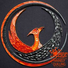 an orange and black bird sitting on top of a circular piece of art with chains around it