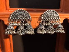 Add charm and charisma to your beautiful personality with these exquisitely designed and handcrafted high quality German Silver earrings in antique look. Pair them up with any formal or semi formal attire and gather compliments wherever you go. Suitable for both casual and dressy occasions. Note: All in stock items will be shipped from New Delhi, India within 2-3 business days after receipt of payment. International orders may take anytime between 3 to 5weeks for your shipments to reach you. som Vintage Chandbali Jhumkas With Latkans, Vintage Chandbali Jhumkas For Festivals, Vintage Chandbali Jhumkas For Festive Occasions, Festive Vintage Earrings With Oxidized Finish, Vintage Danglers With Latkans For Festive Season, Festive Vintage Danglers With Latkans, Traditional Earrings With Antique Finish For Festivals, Traditional Antique Finish Earrings For Festivals, Vintage Oxidized Danglers For Festive Occasions