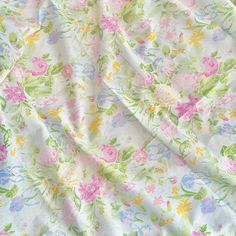 an image of a flowered fabric that is very soft and colorful with lots of flowers on it