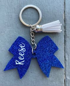 a keychain with a blue bow and the word relax on it's side