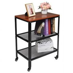 a book shelf with books and flowers on top