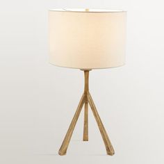 a wooden table lamp with a white shade on the base and a light in front of it