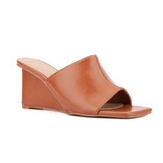 Whether you're heading out for a night on the town or enjoying brunch with friends, the Candie has you covered. This open-toe mule features a chic wedge that combines style with comfort, making it perfect for all-day wear. The versatile design effortlessly complements any outfit, ensuring you look fashionable from day to night. With its blend of elegance and practicality, the Candie is a must-have addition to your wardrobe, offering both sophistication and ease for any occasion. Spring Night Out Wedge Sandals, Summer Wedge Mules With Padded Heel, Spring Slide Mules With Padded Heel, Summer Mules With Padded Wedge Heel, Chic Summer Wedge Sandals With Stacked Heel, Formal Slide Sandals For Spring, Spring High Heel Wedge Sandals For Night Out, Trendy Wedge Sandals For Night Out In Spring, Elegant Wedge Heel Mules For Beach