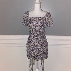 Floral Ruched Dress. Nwot Summer Dresses With Ruched Sides And Square Neck, Spring Square Neck Dress With Ruched Sides, Spring Dresses With Ruched Sides And Short Sleeves, Casual Purple Ruched Mini Dress, Casual Summer Dresses With Ruched Sides, Blue Drawstring Dress For Day Out, Purple Ruched Mini Dress For Beach, Purple Ruched Mini Dress For The Beach, Fitted Sundress With Drawstring