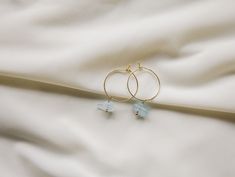 The way the light blue compliments the gold, the simplicity of the two aquamarine gemstones, and the minimalistic feel from the hoops make these earrings the perfect everyday hoops adding a delicate touch of color.  D E T A I L S - 18k gold plated 20 mm hoop.  - Two beautiful aquamarine gemstones. Each gemstone is unique and will vary in size, shape, and color.  - Earring hook is gentle on the ears and feels secure.  - Comfortable and light to wear.  ∙ EXTRAS  - Handcrafted with a lot of love.   - All of my jewelry arrives tightly wrapped.  - If this is a special gift or if you would like a customization just let me know in the message box at checkout.  ∙ MY SHOP Check out more of my pieces - https://www.etsy.com/shop/ashlikitta?ref=simple-shop-header-name&listing_id=1384487927 ∙ FIND ME O Blue Dainty Hoop Jewelry, Elegant Blue Small Hoop Jewelry, Blue And Gold Earrings, Handmade Small Hoop Blue Earrings, Blue Handmade Minimalist Hoop Earrings, Aquamarine Hoop Earrings, Aquamarine Gemstone, Aquamarine Blue, Aquamarine