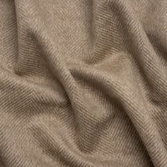 Brave the cold in this Dark Beige and Cream Herringbone Brushed Wool Blend Twill Coating, displaying a dark beige and cream herringbone pattern across its fuzzy, slightly tactile face and reverse. It features a subtle luster and a malleable drape. A lining will increase warmth and structure but is not necessary.

An easy way to elevate your look while staying warm, high-quality wool outerwear brings a chic maturity to your street, corporate, or formal style. The impact of a wool coat—be it oversized, fitted, wrap-around, or trench—is timeless, promoting practical fashion through a heavyweight feel. Though the wind is sharp, you’ll suddenly find yourself eager to walk the cold city streets in your new winter staple... (thank you, Mood!) Woollen Fabric, Mood Designer Fabrics, Twill Coat, Practical Fashion, Mood Fabrics, Diagonal Stripes, Stripe Silk, Dark Beige, Formal Style