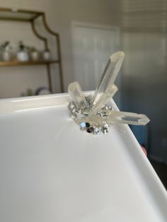 a diamond ring sitting on top of a white table