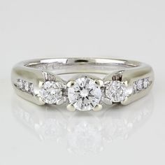 a white gold ring with three diamonds on it