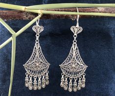 Our  Chandelier /Dangle Boho) filigree women's earrings are made of  925 sterling silver.  Specially oxidized to achieve the authentic look. Weight; 9g Size: approx 6.7cm x 2.6cm Our company started its activities in 2019, has recently decided to open the silver jewelery which is produced highly qualified and in a unique style with the filigree technique at the local level, to the world markets and has started its activities for this purpose. Researches by archaeologists reveal that silver jewelry has been accepted as an indispensable product since ancient times. Again, researches reveal that people have produced ideas on silver jewelry and produced different techniques for jewelry making throughout history. One of the most striking of these techniques is the filigree technique. Filigree i Classic Filigree Dangle Chandelier Earrings, Classic Filigree Chandelier Dangle Earrings, Classic Filigree Chandelier Earrings, Classic Filigree Chandelier Earrings As Gift, Classic Filigree Chandelier Earrings For Gift, Filigree Sterling Silver Chandelier Earrings For Gift, Sterling Silver Filigree Chandelier Earrings As Gift, Sterling Silver Filigree Dangle Chandelier Earrings, Sterling Silver Filigree Chandelier Earrings