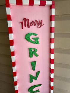 a pink sign that says merry gravy on the side of a house with red and white stripes