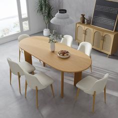 a dining table with white chairs around it