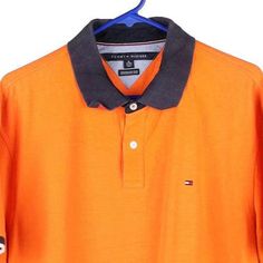 Description:Vintage orange Tommy Hilfiger polo shirt, fits x-large.GENDER: mens CONDITION: very goodSTYLE: polo shirtERA: 1990sCOLOUR: orangeFABRIC: cotton Classic Orange Collared Top, Casual Orange Collared T-shirt, Orange Collared Cotton Polo Shirt, Orange Cotton Collared Polo Shirt, Classic Orange Collared Shirt, Tommy Hilfiger Polo Shirt, Tommy Hilfiger Polo, Vintage Orange, Shirt Fits