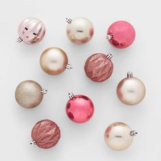 christmas ornaments are arranged in different colors and sizes on a white surface, top view