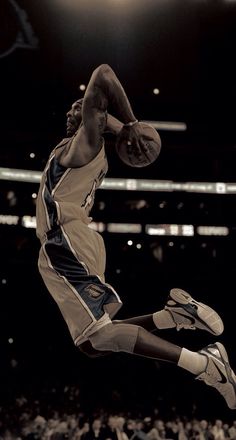 a basketball player is jumping in the air