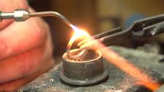 someone is working on an object with a lighter