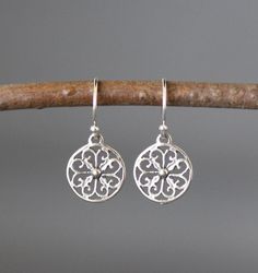 "Sweet, small and lightweight round Bali Silver filigree charms simply dangle from silver earwires. Choose from balled silver earwires (as shown and sent with stoppers for the ends of the wires) or plain leverback earwires (these close in the back). These go-with-everything earrings are perfect to wear everyday. Bali Silver charms: 11mm Total length of earrings: 1\" All silver is sterling. As the owner, maker, designer, and curator of this shop, I take great pride in providing you with jewelry that you will love to wear everyday, for special occasions, and for many years to come.  Please read my Shop Policies which contains important information regarding Payment, Shipping, Refunds, Jewelry Care, and other details. www.etsy.com/shop/thetimeoutcollection/policy To see more beautiful jewelry Sterling Silver Pierced Round Pendant Earrings, Adjustable Delicate Silver Earrings, Elegant Round Pendant Earrings With Ear Wire, Dainty Round Pierced Plug Earrings, Sterling Silver Earrings With Round Pendant And Ear Wire, Delicate Pierced Round Earrings, Dainty Circular Earrings, Delicate Round Pierced Earrings, Dainty Circle Earrings For Pierced Ears