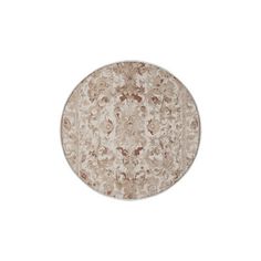 a round rug with an intricate design on the top and bottom, in beige tones