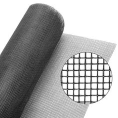 a roll of black wire mesh on top of a white surface with a circle in the middle