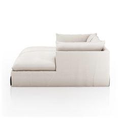 a white couch sitting on top of a white floor