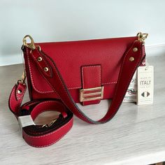 Nwt Divina Firenze Italy Red Pebbled Leather Crossbody Flap Baguette. Features: * Gold Tone Hardware * Accent Buckle * Foldover Snap Closure * Detachable Crossbody Strap 42”- 48” Ext. * * Black Fabric Lined Interior * Interior Zip Pocket * Bottom Feet Protectors All Pics Taken By Seller. This Is The Exact Bag You Will Receive. Luxury Baguette Bag With Detachable Strap, Designer Red Flap Bag For Shopping, Luxury Baguette Bag For Shopping, Red Crossbody Flap Bag For Formal Occasions, Designer Red Flap Shoulder Bag, Designer Red Flap Bag For Everyday Use, Luxury Baguette Shoulder Bag With Detachable Strap, Red Luxury Shoulder Bag For Daily Use, Designer Baguette Shoulder Bag With Adjustable Strap